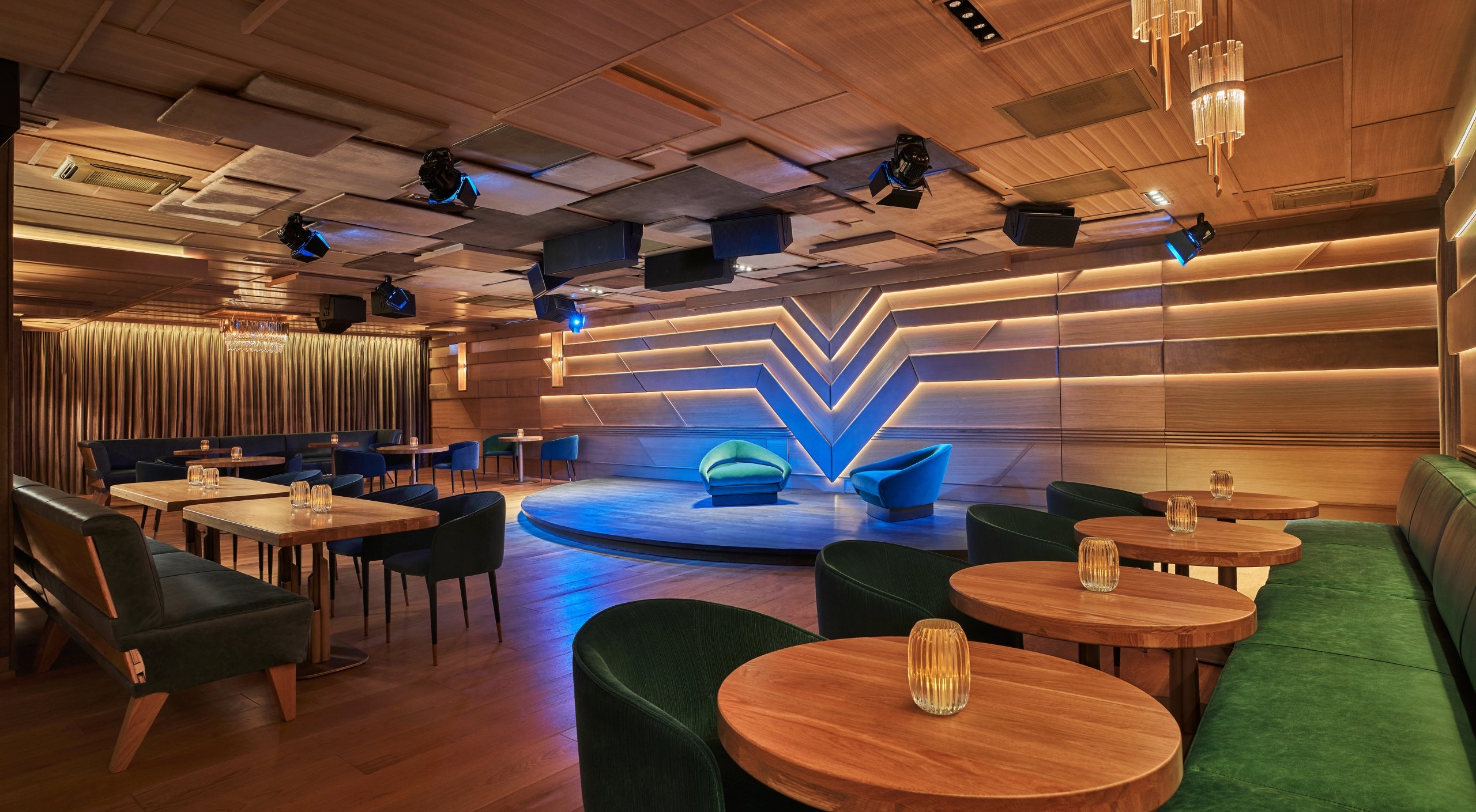 The Sun Rose lounge area set up with tables and chairs and a large platform for performances