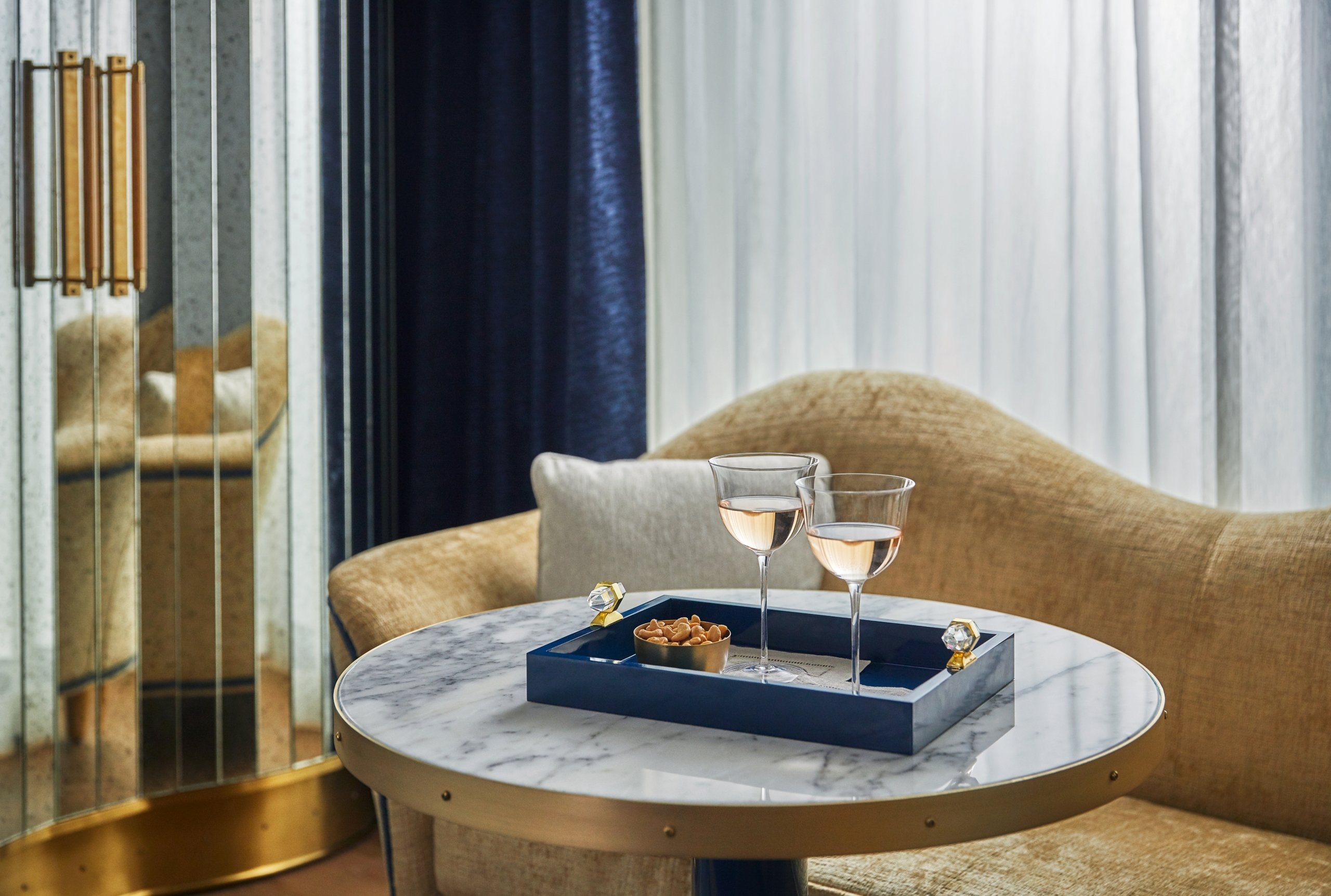 Close up of a tray holding two drinks and a dish of nuts at The Sun Rose