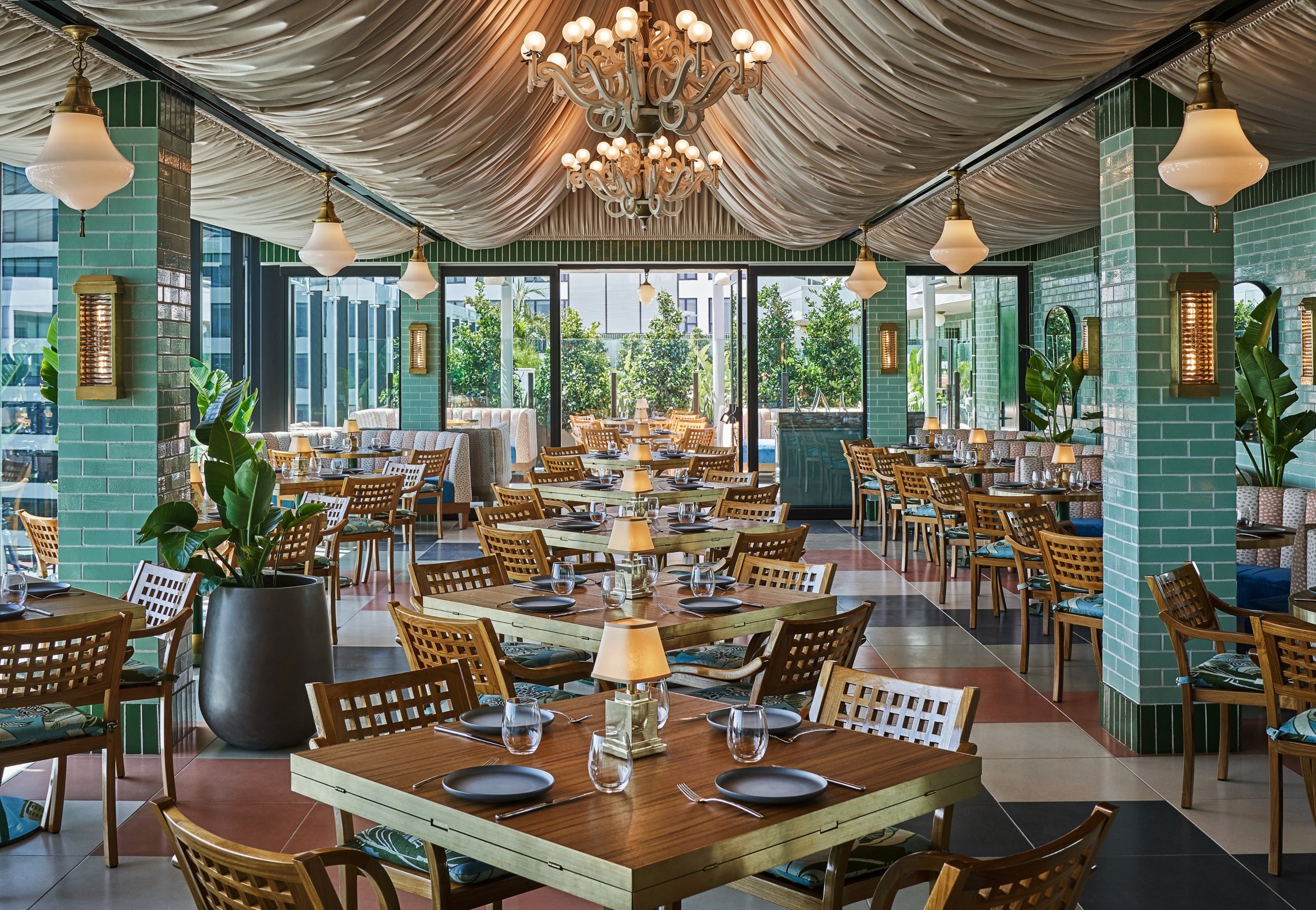 Large indoor dining area at Merois with tables and booths all along the room at The Sun Rose