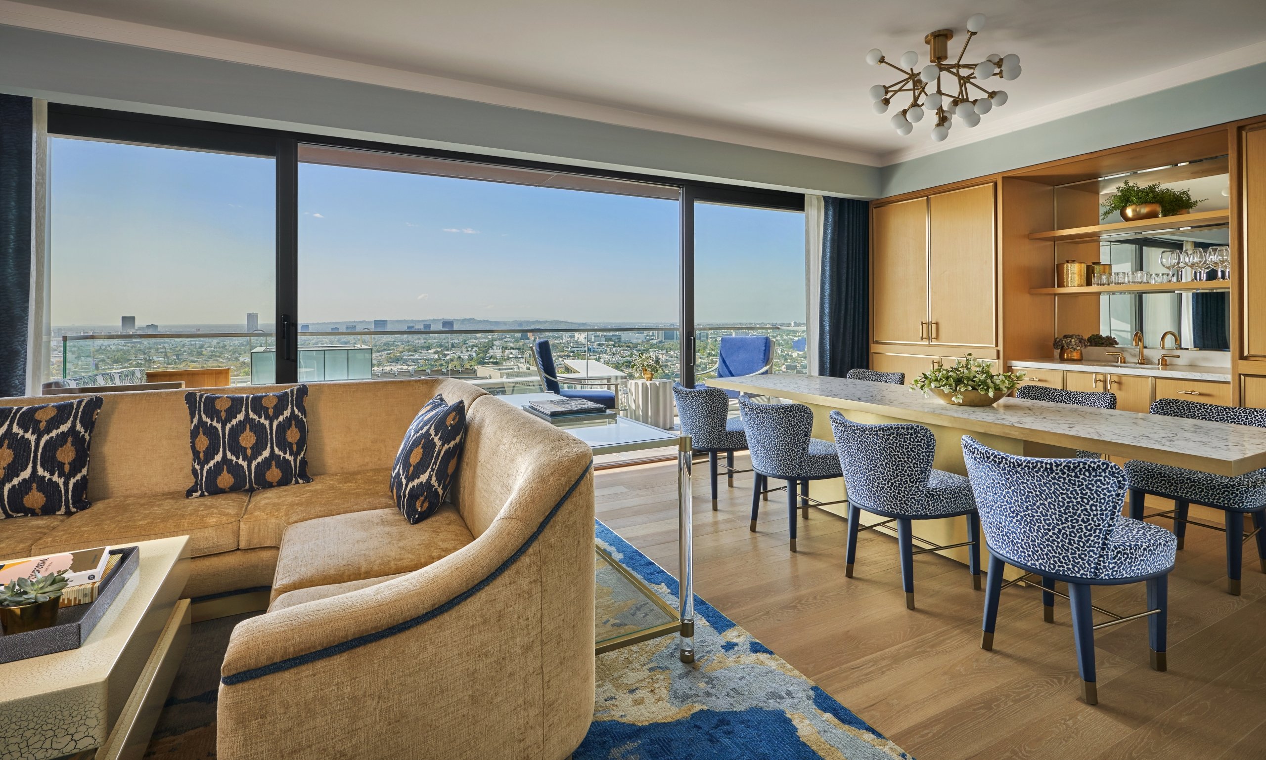 The Sun Rose suite living room with a long table, couch and amazing views of west hollywood