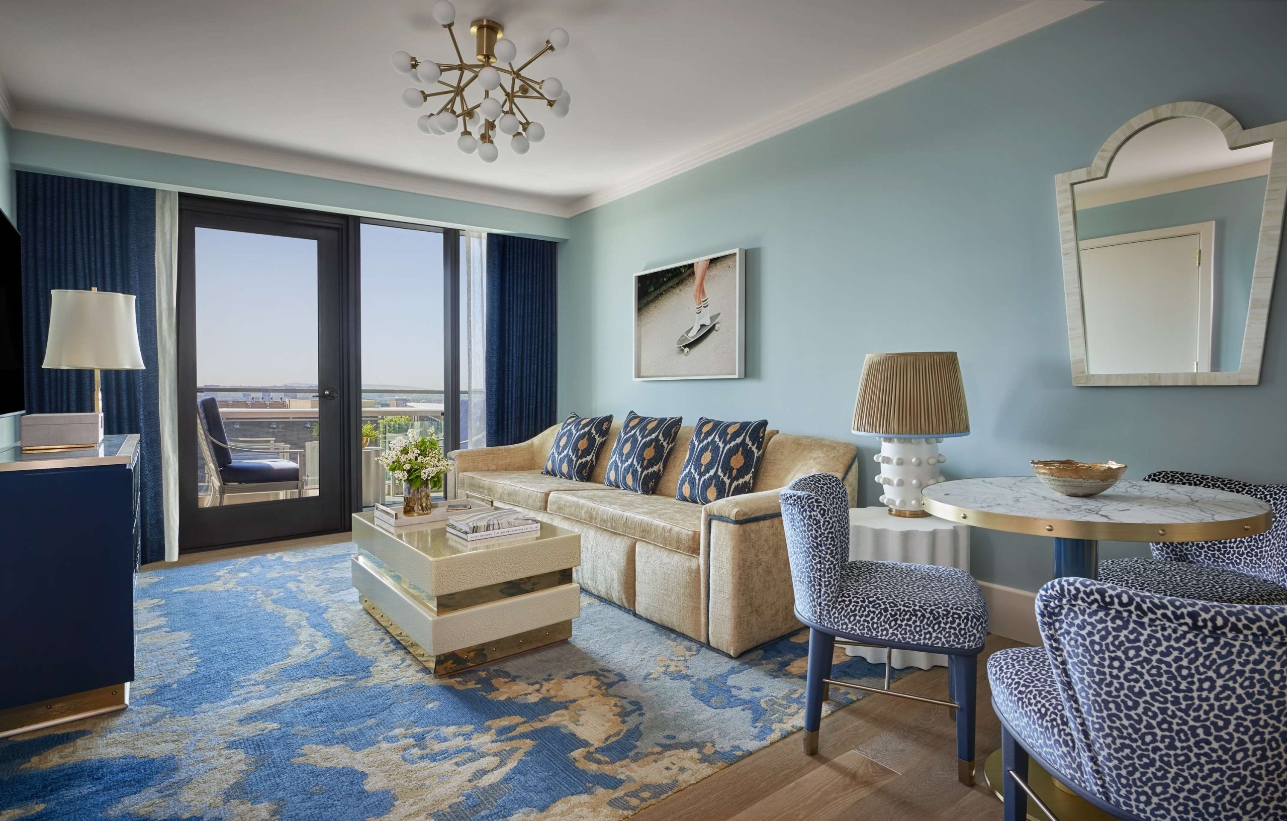 Living room space in a room at The Sun Rose with an outdoor patio in the background