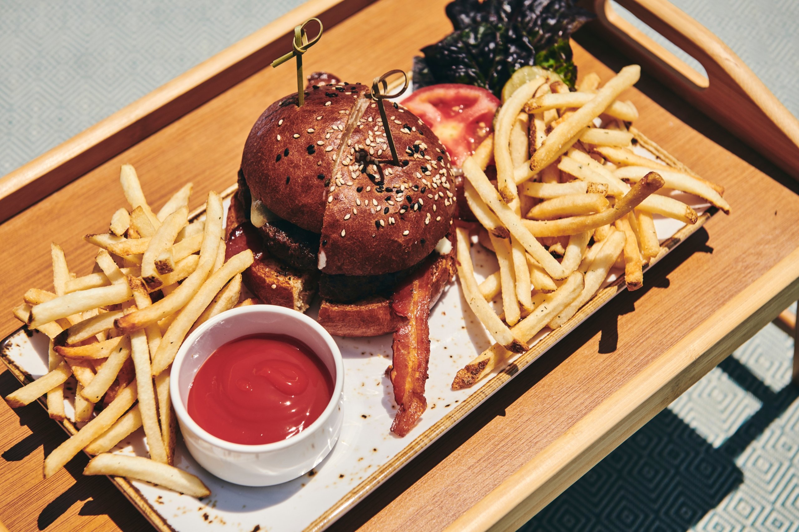 Close up of a burger and fries on a plate prepared by The Sun Rose