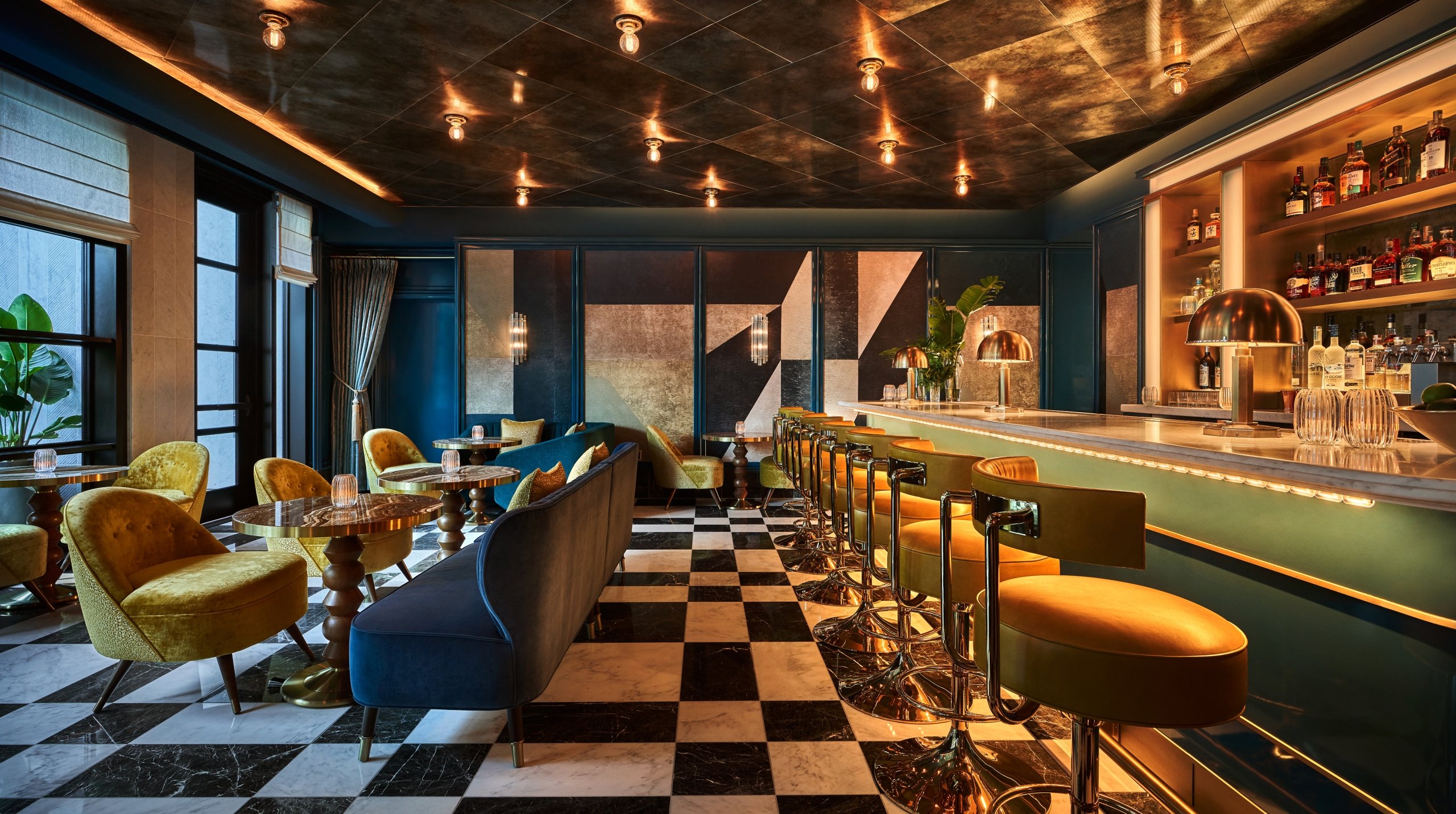 The Bar at The Sun Rose with bar seating and tables in the background