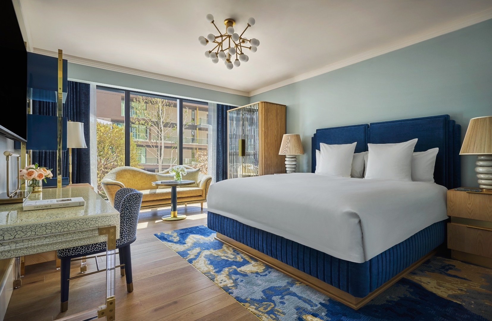 Interior view of a bed room at The Sun Rose with a large bed a couch and a desk