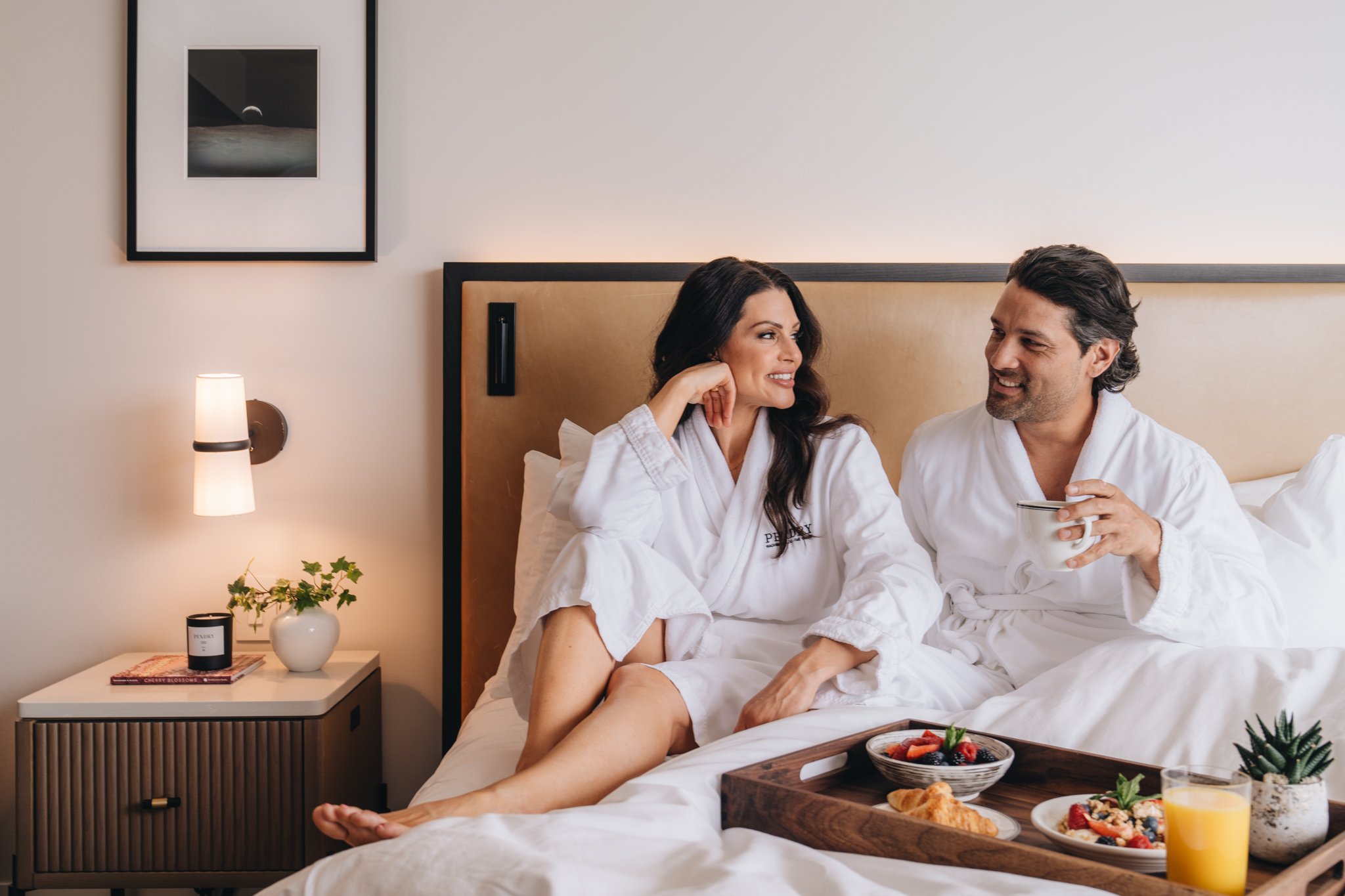 A couple enjoying breakfast in their bed at The Sun Rose