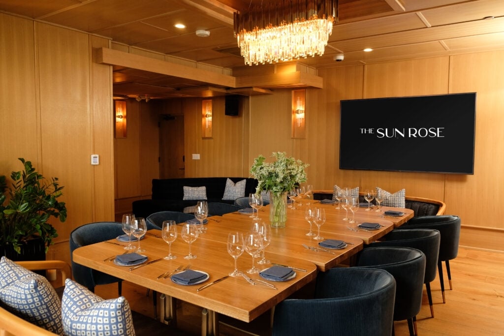 A meeting space at The Sun Rose with. tables and chairs set up