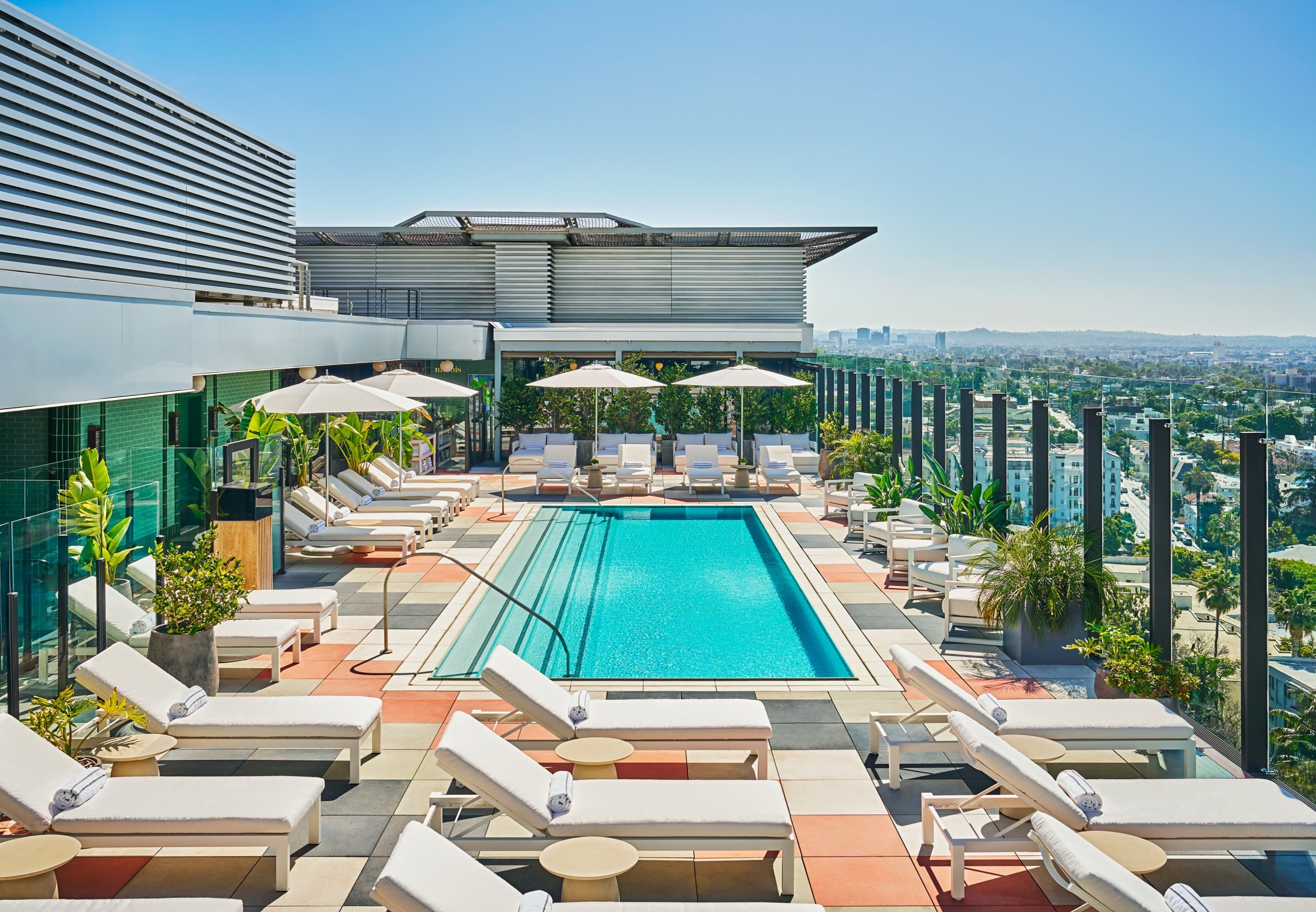 The Pool at The Sun Rose with lots of lounging chairs for guests