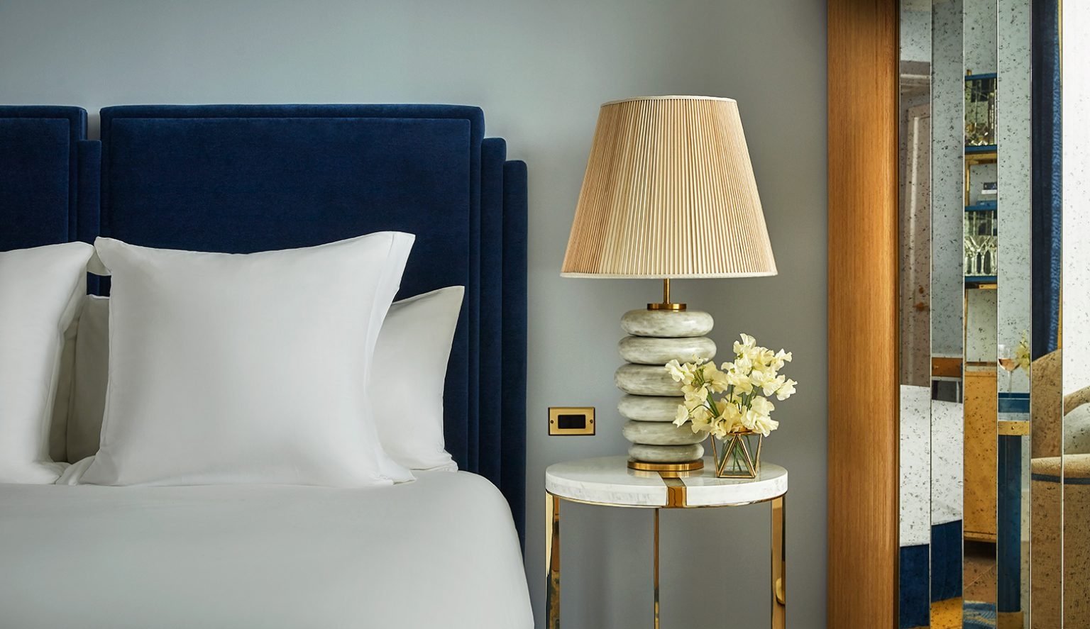 Close up of a table sitting next to the bed in a room at The Sun Rose