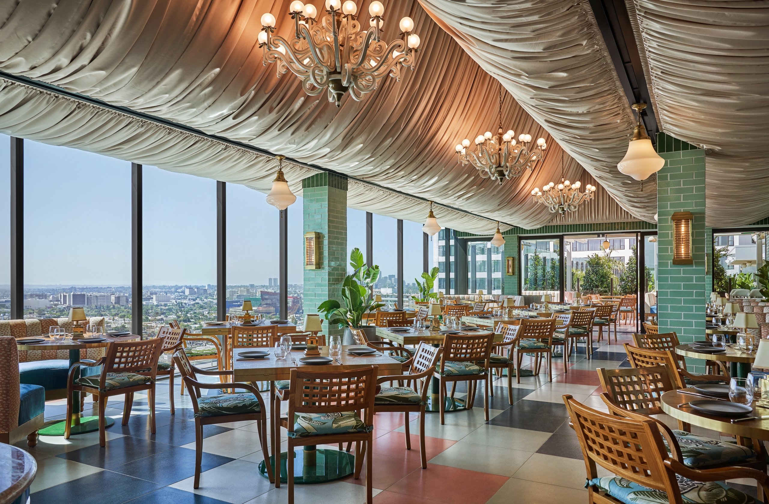 Merois dining area with many tables set up for service and view of West Hollywood