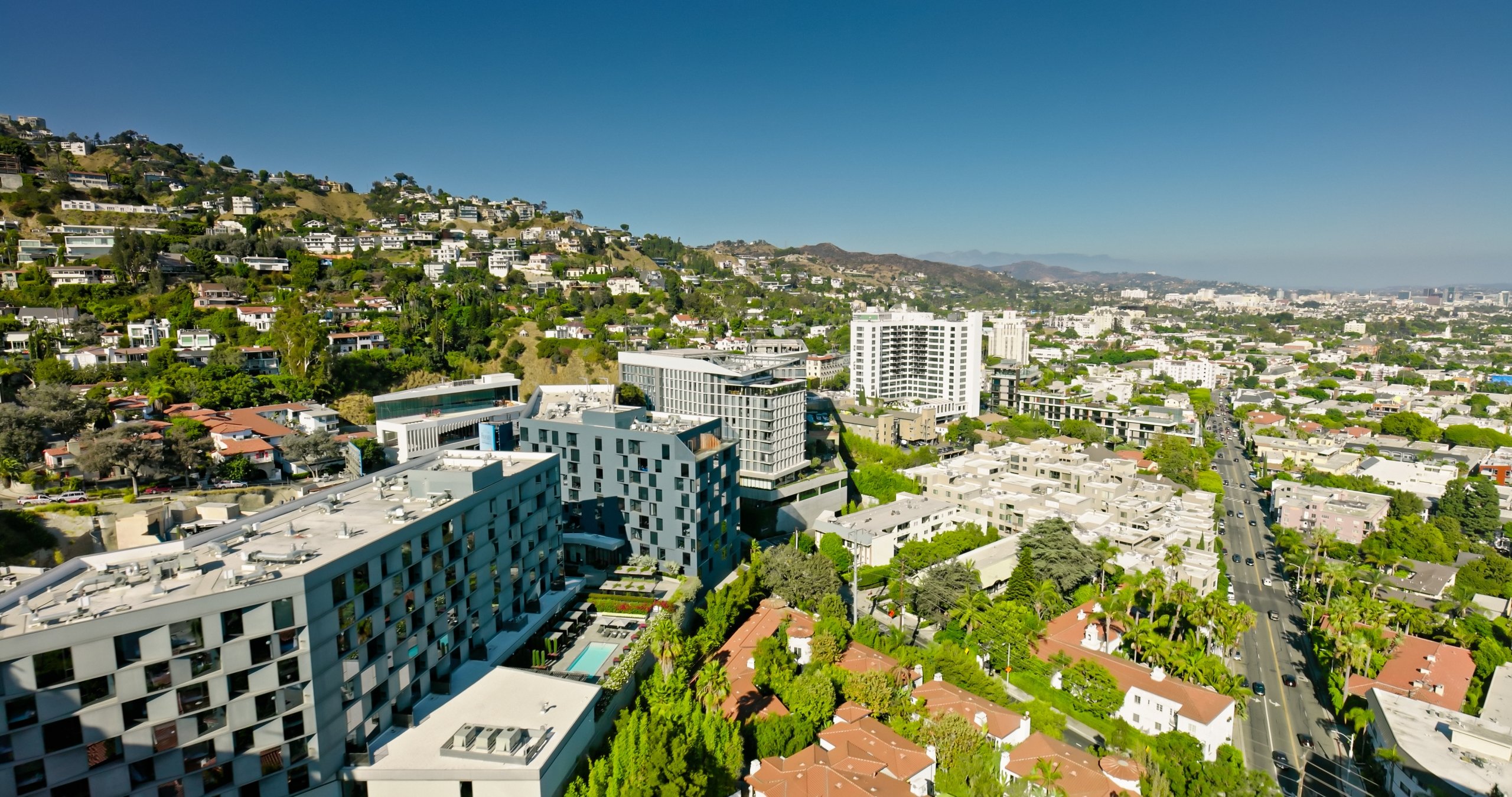 Aerial shot of the Hollywood Hills in Los Angeles, California on a sunny day.