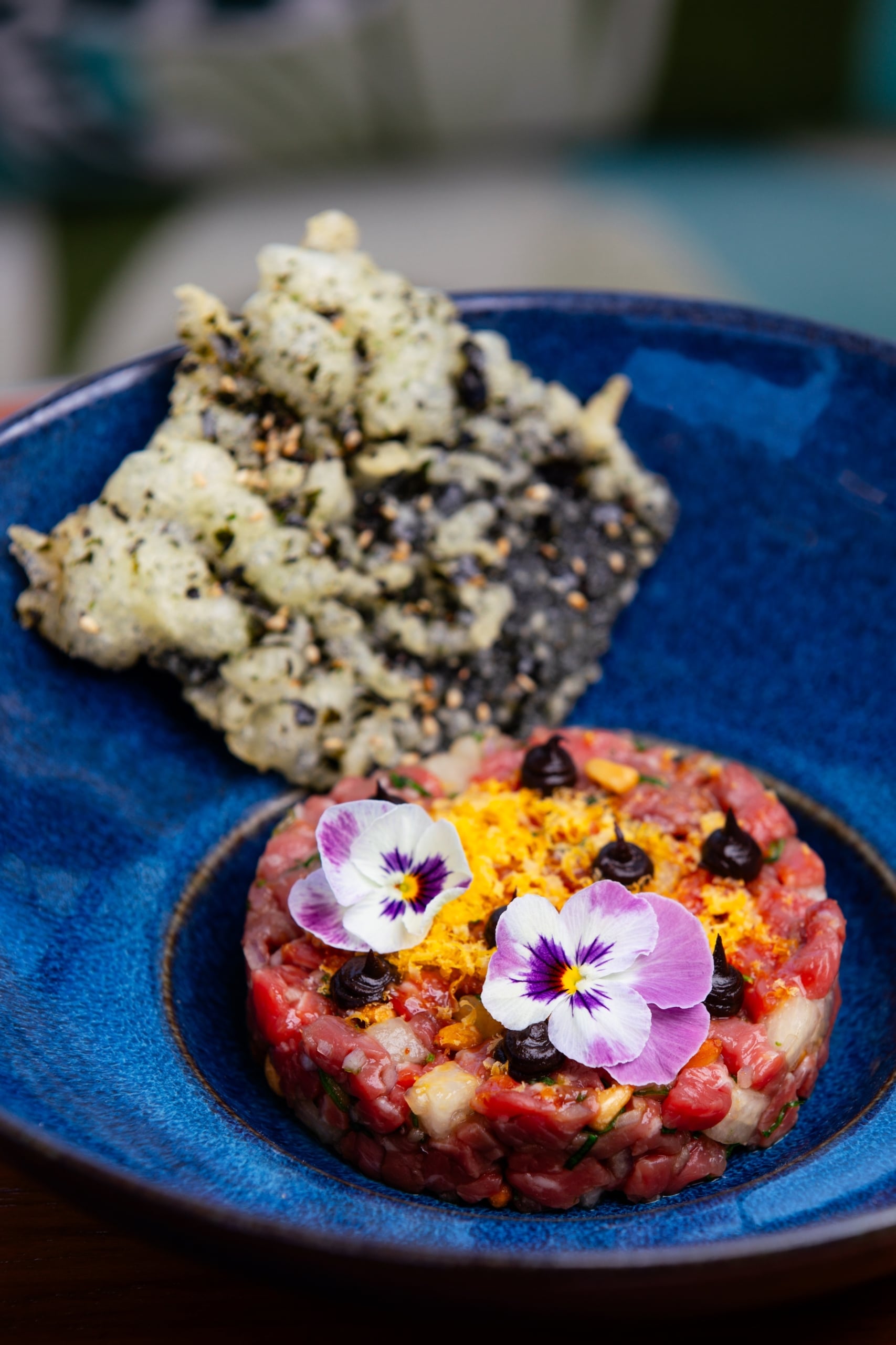 A plated wagyu beef tartare dish.